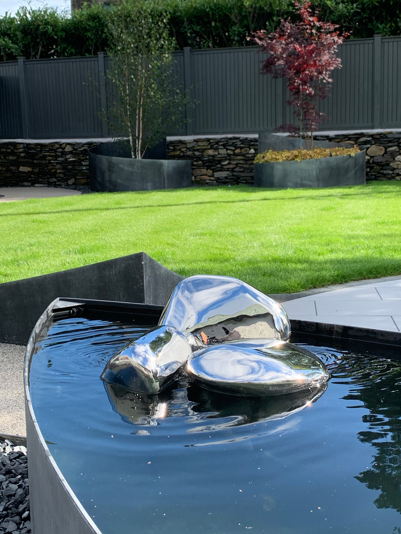 Mirror-polished pebbles create a stunning water feature.